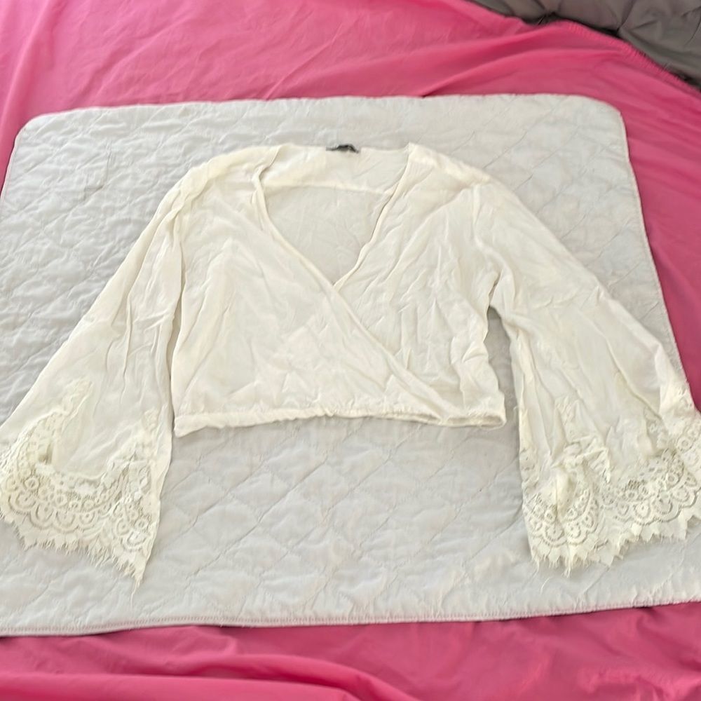Unique top cream colored with lace sleeves crisscross front by girl obsessed M